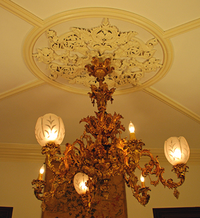Ornate four-tier brass chandelier from the Victorian period in the John Thompson House