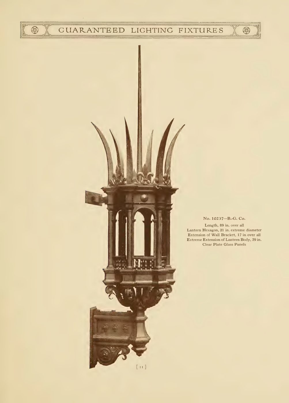 A tall Gothic wall lantern with pointed crown details and a heavy backplate.